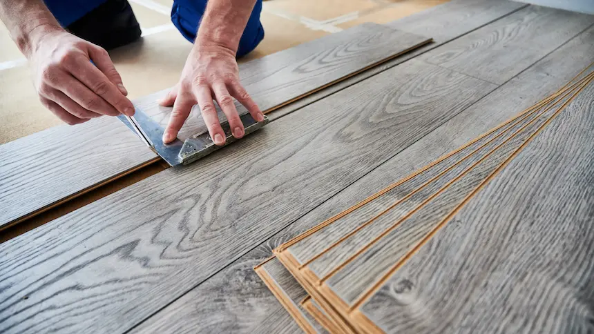 male worker hands drawing line on laminate wood