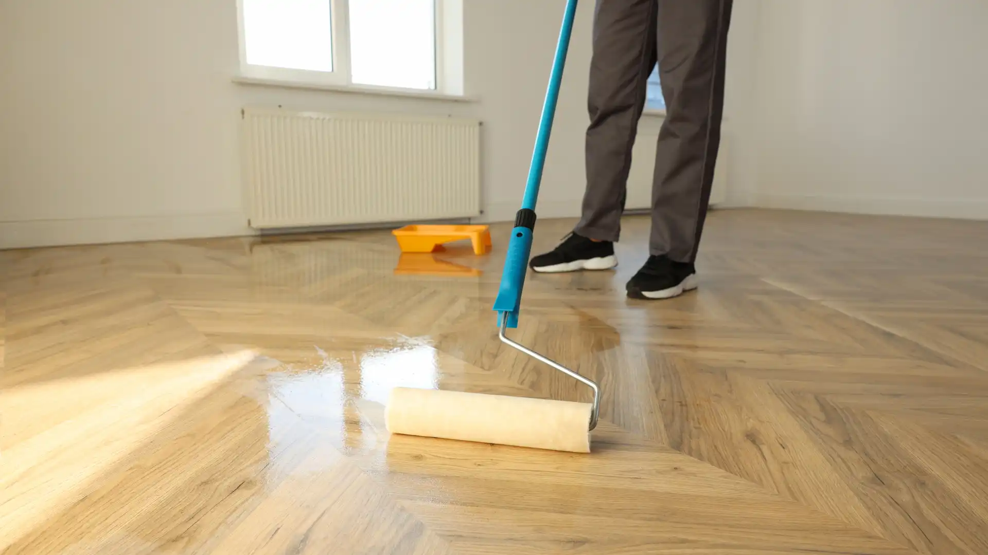 man polishing parquet with varnish indoors close