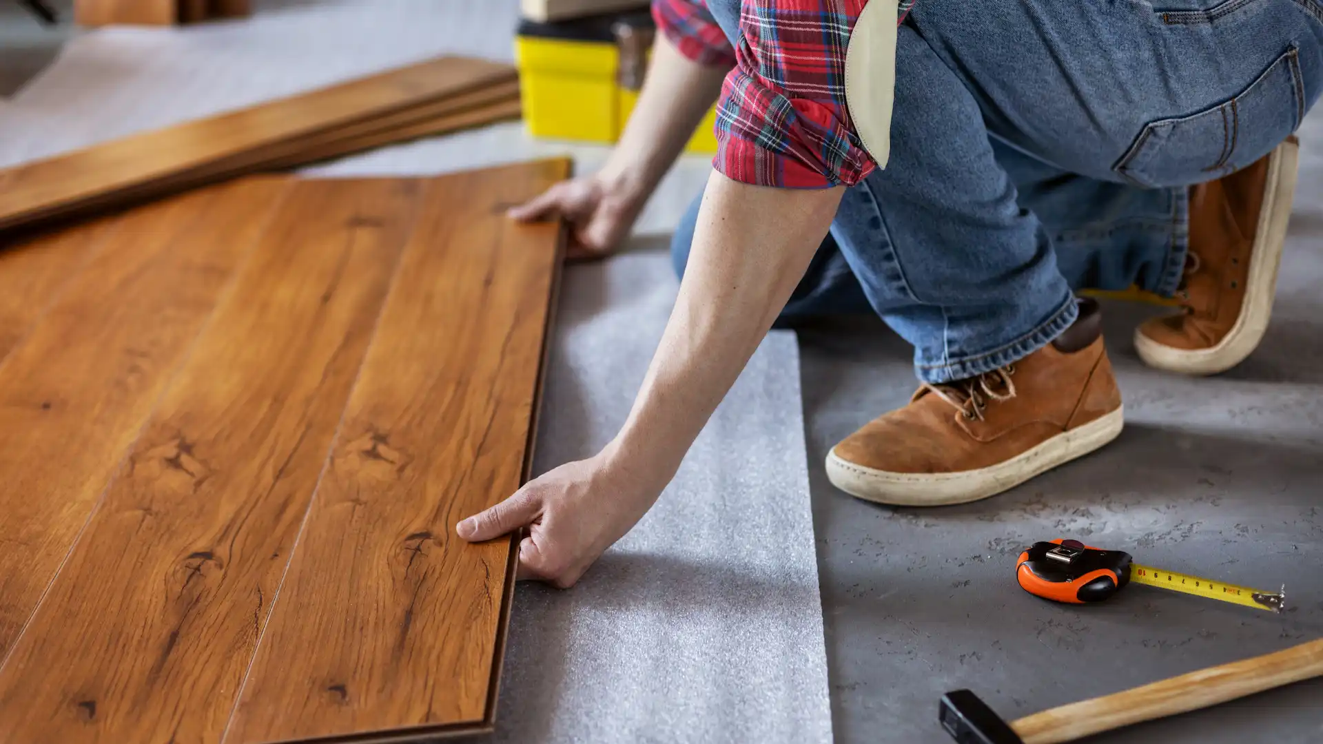 man worker installing laminate flooring wooden