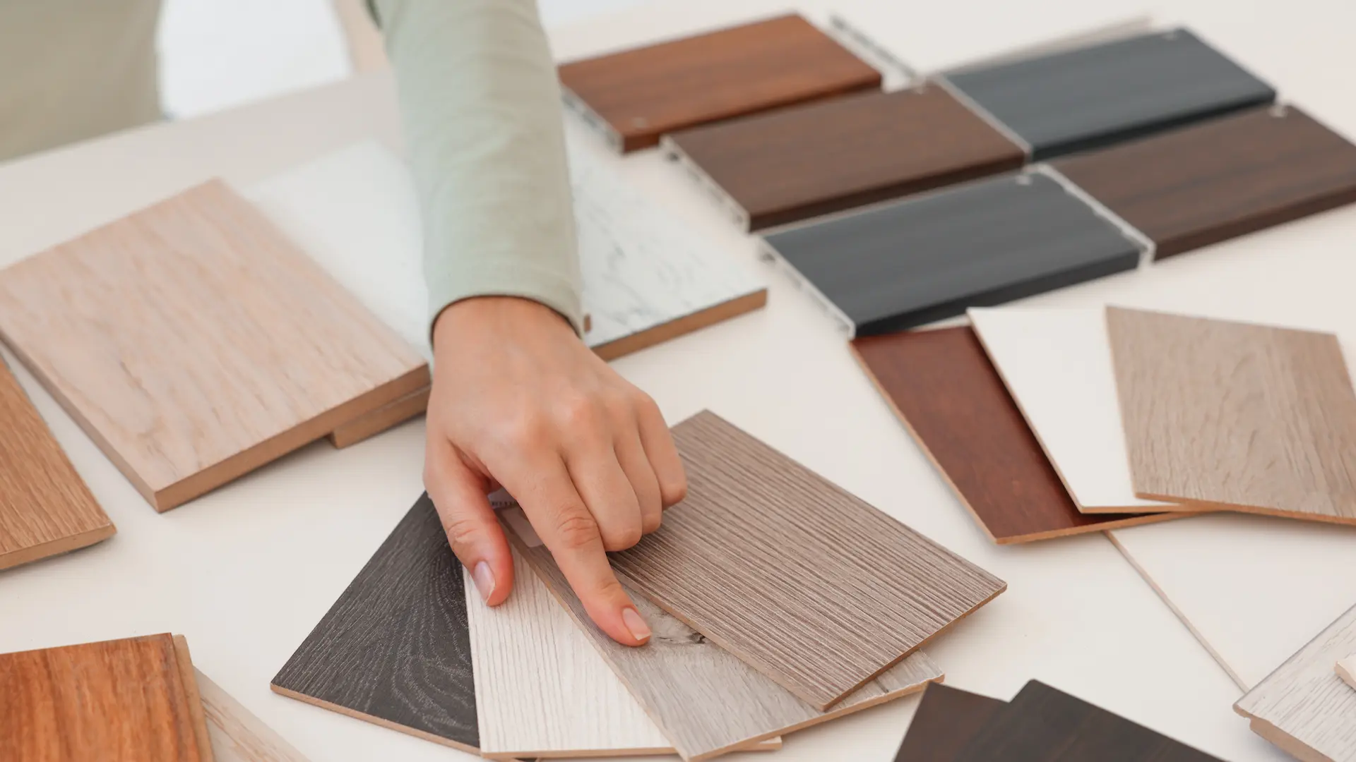 woman choosing wooden flooring among different