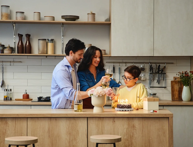 Family celebrating a birthday in the kitchen