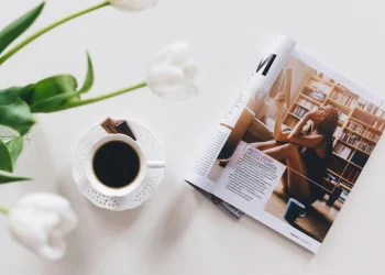 Coffee beside open magazine