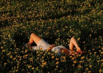 Person lying in flowers
