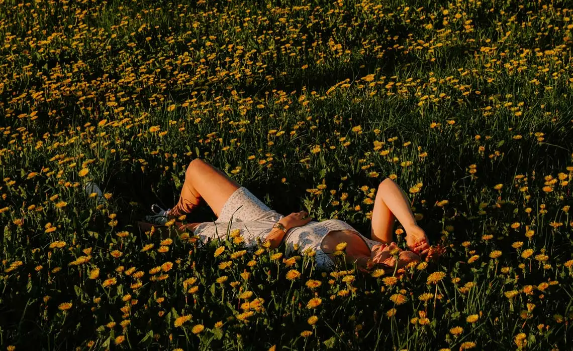 Person lying in flowers