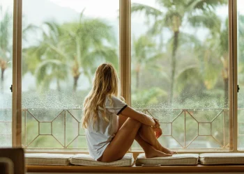 Woman relaxing by window