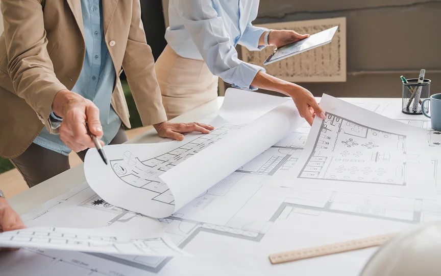 collaborative team analyzing architectural blueprints