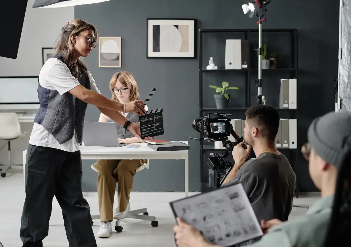 woman using clapperboard to start scene