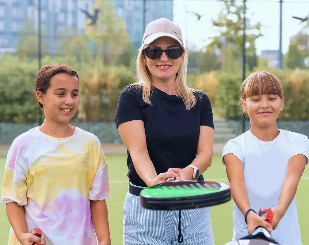 mother and daugther playing padel outdoor