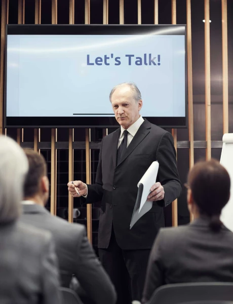 senior business speaker listening to audience