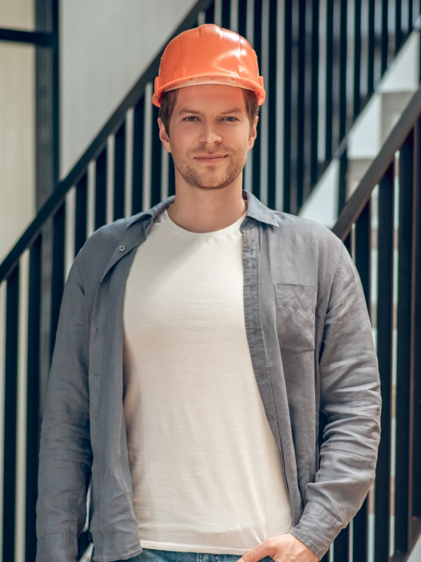 Man in safety helmet with sketch in hand