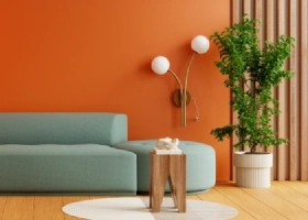 Modern cozy reading corner with orange wall