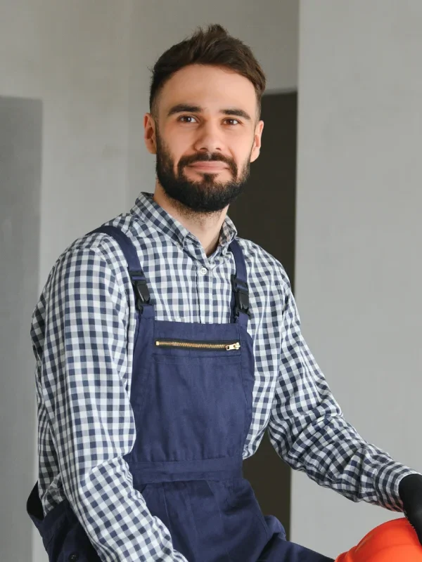 portrait of handsome mechanic in blue jumpsuit
