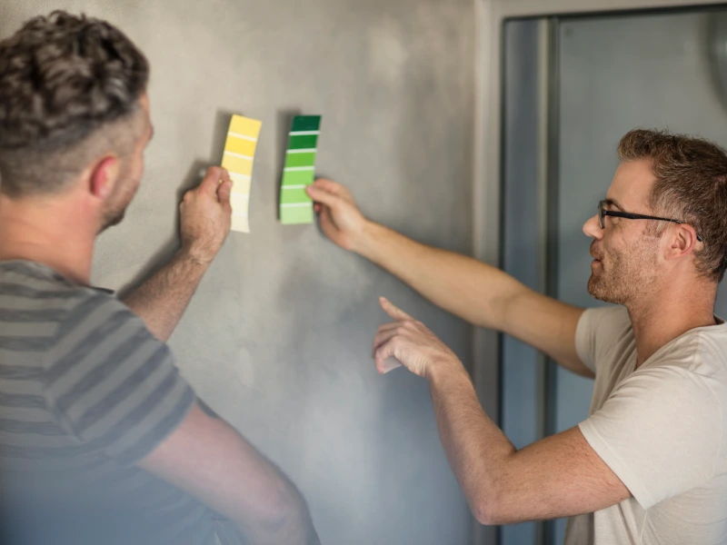 two men comparing paint swatches