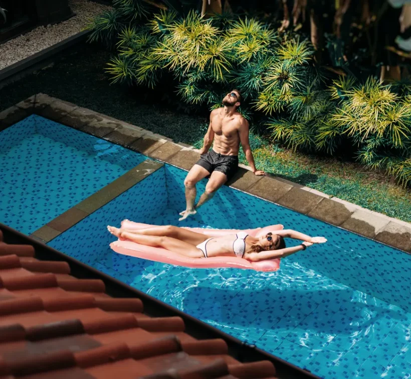couple relaxing by the pool couple outside