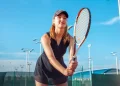 a beautiful young woman plays tennis
