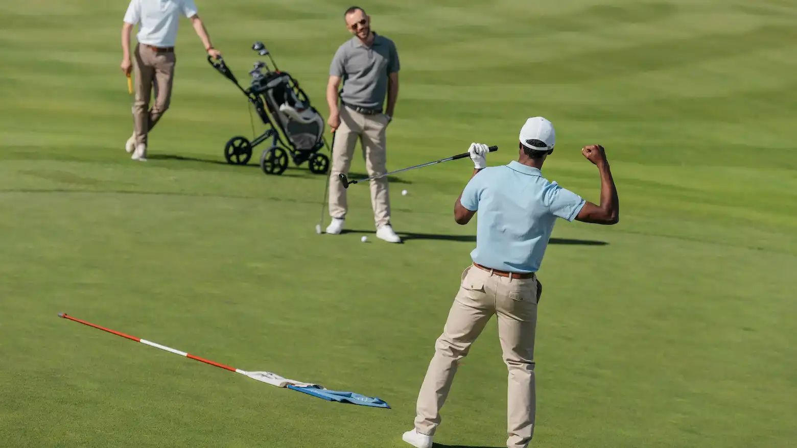 african american golfer celebrating success team