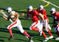 american football players chasing opposing player