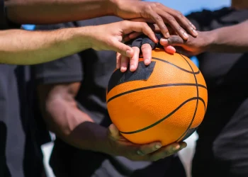 basketball team joining forces with hands