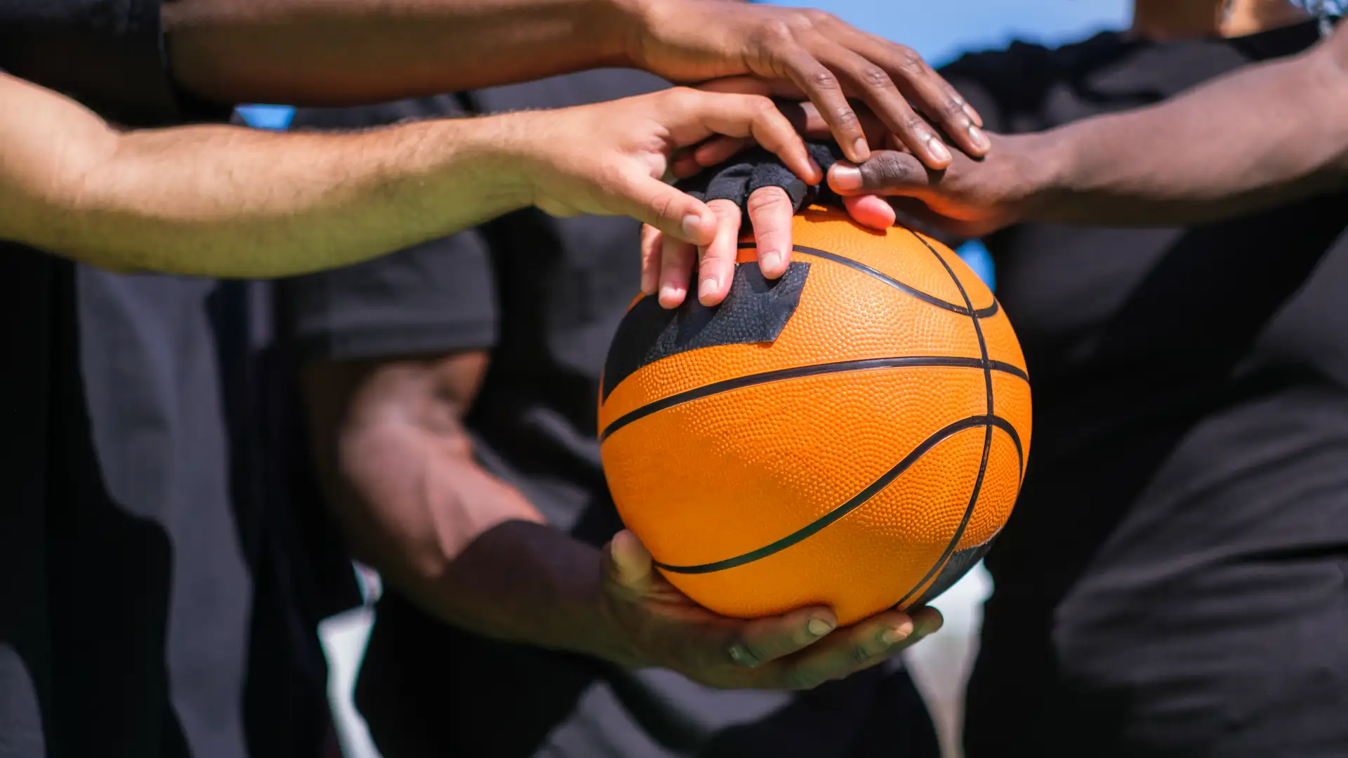 basketball team joining forces with hands