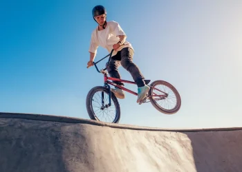 bmx bicycle rider performing footjam trick