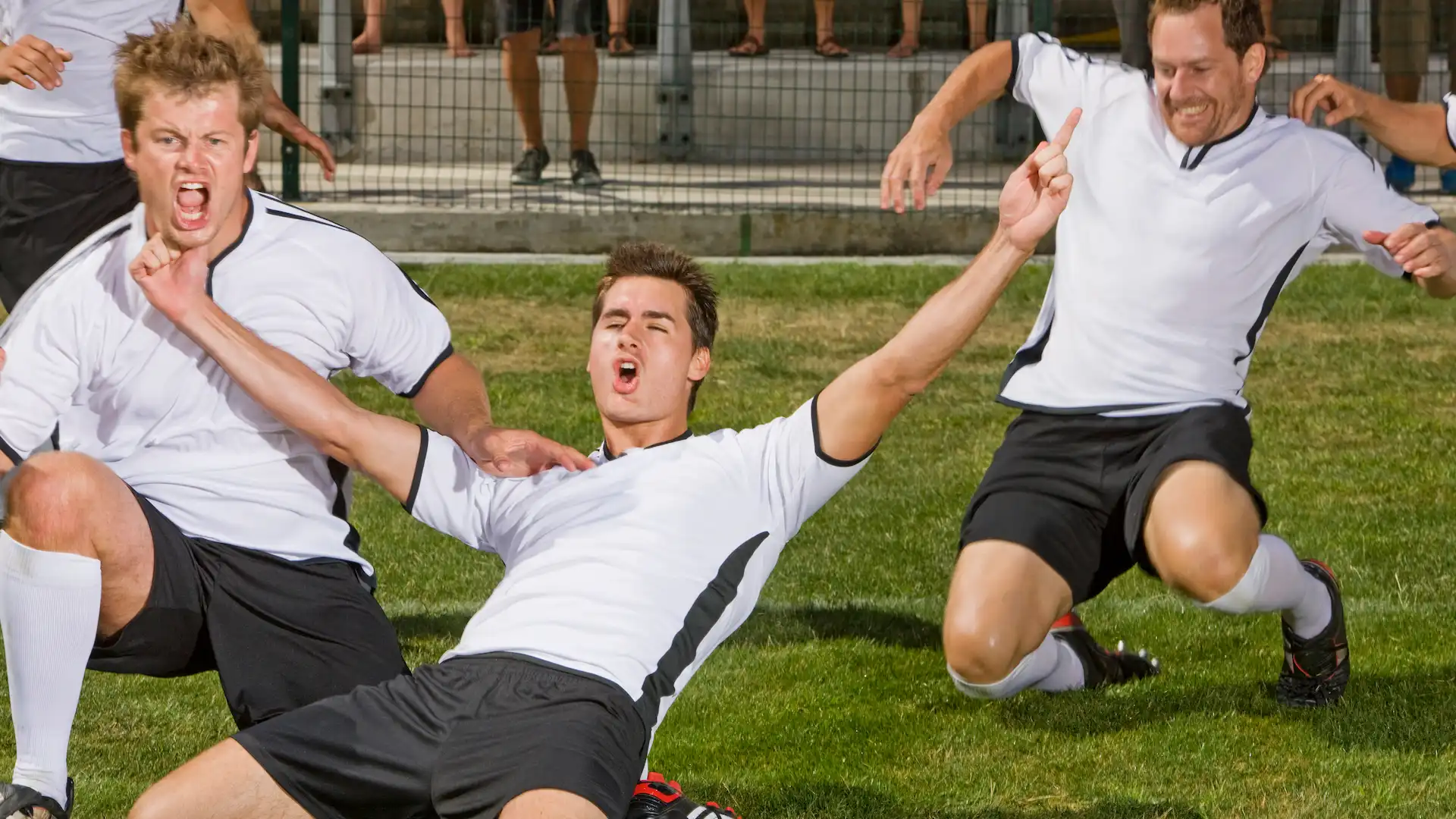 german soccer players celebrating win at game