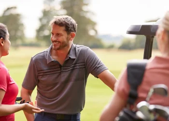 group of male and female golfers standing by golf