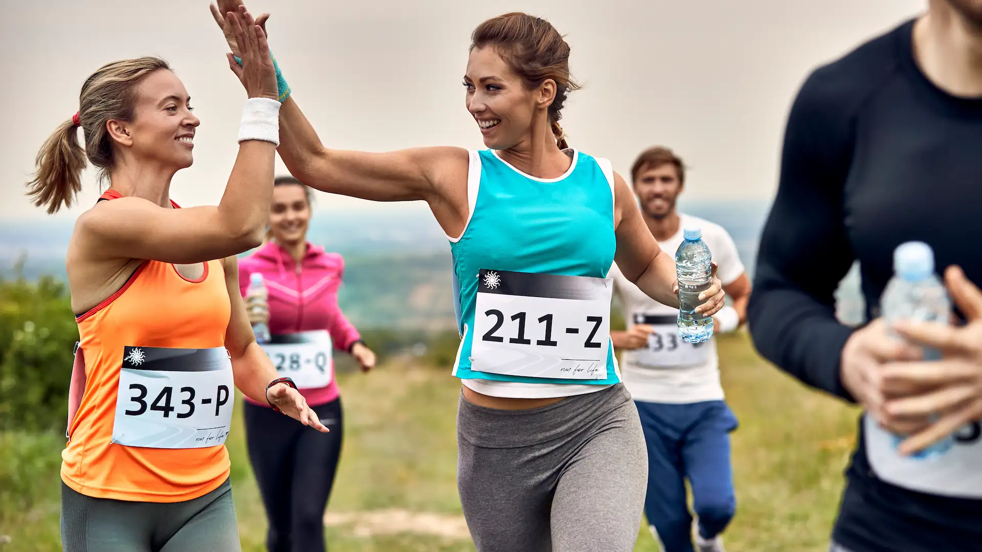 happy marathon runners giving high five