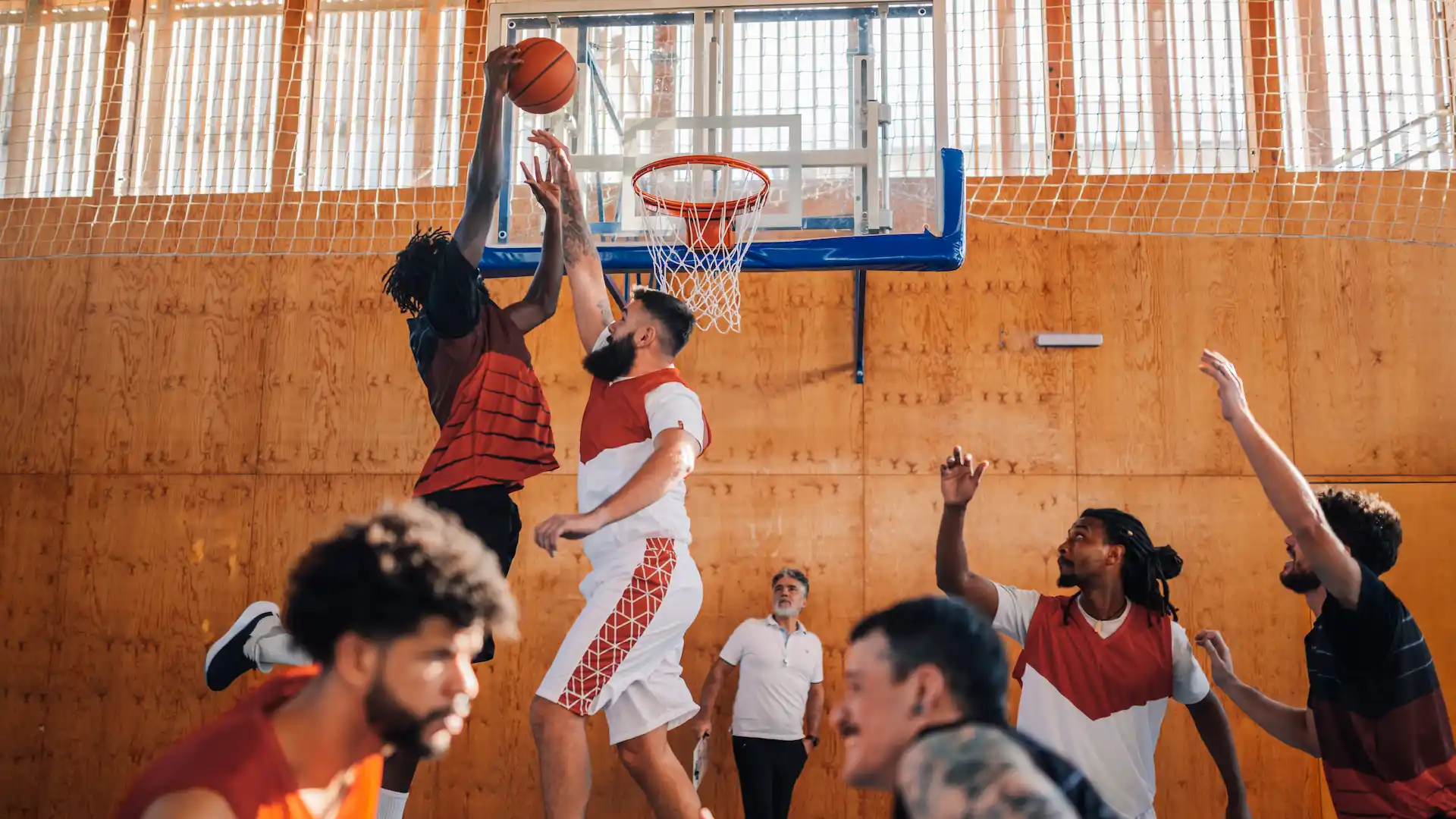 interracial basketball player dunking the ball
