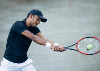 professional tennis player hitting ball