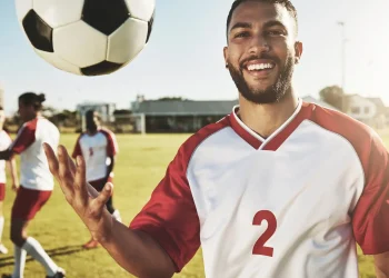 real soccer team training on field and men