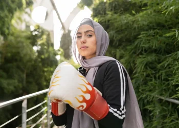 the muslim woman in hijab practicing boxing