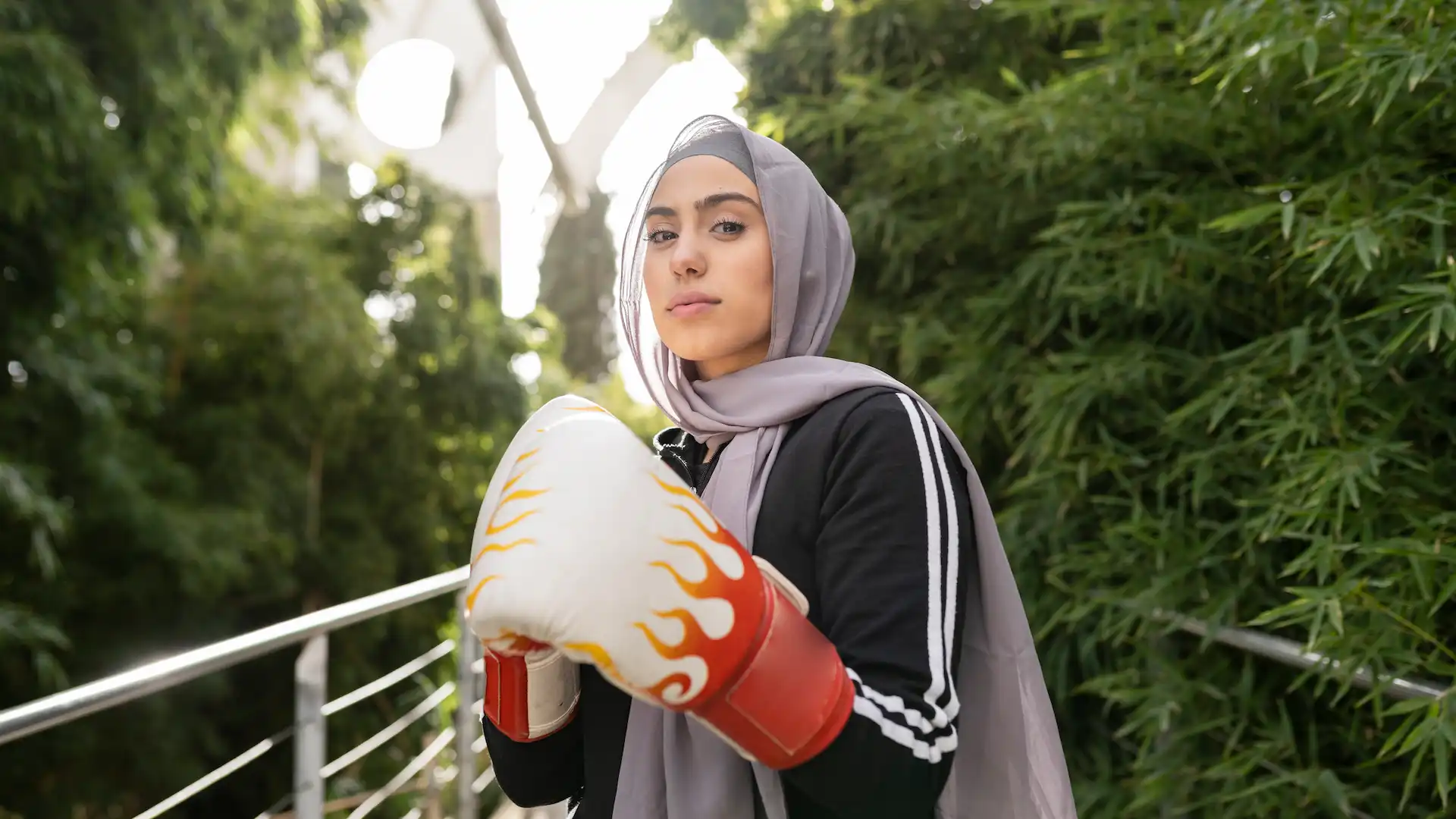 the muslim woman in hijab practicing boxing