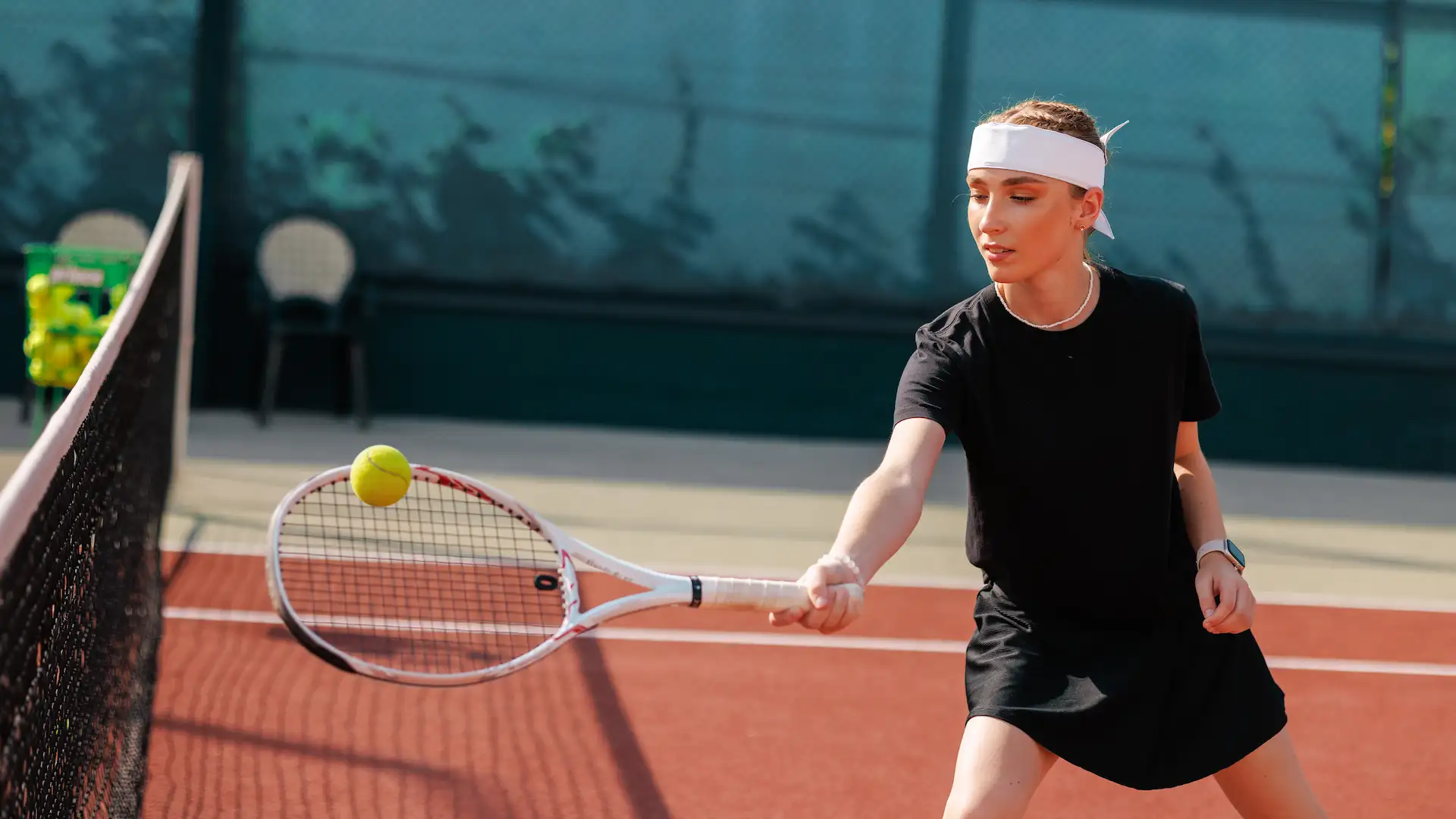 young female tennis player returning