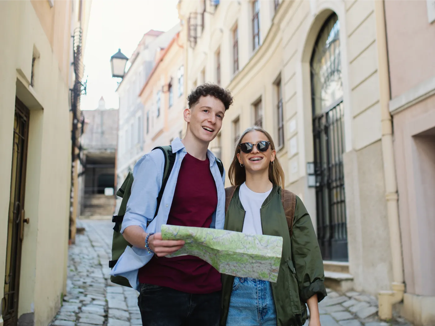 Young couple travelers with map in city on holiday