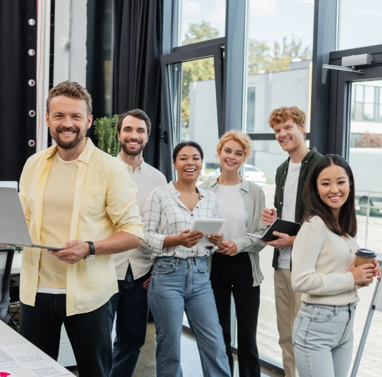 cheerful multiethnic corporate team looking at camera