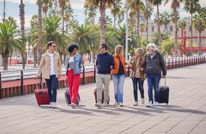 group of mid aged friends walking with their luggage