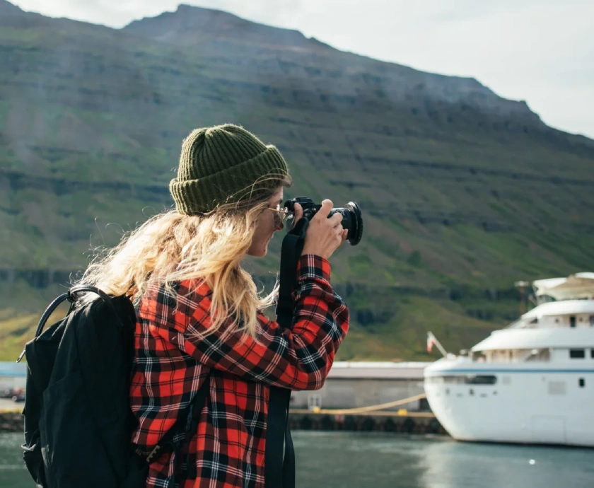 woman makes photos of epic cruise ship in fjord