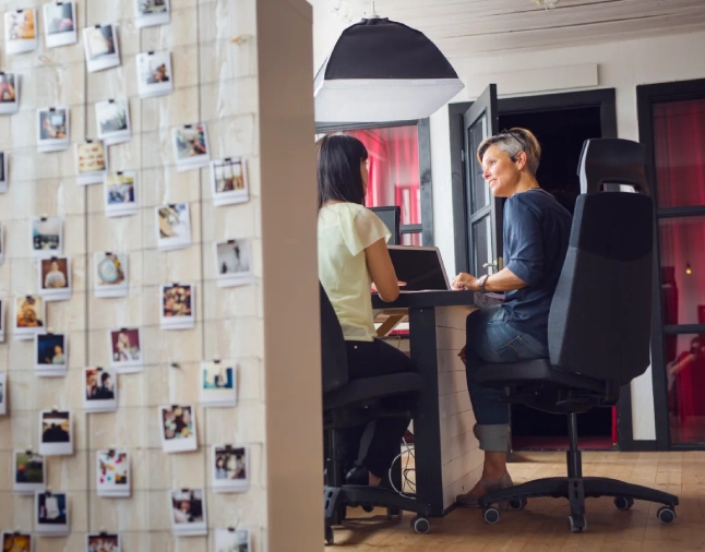 Coworker working in office have discussion