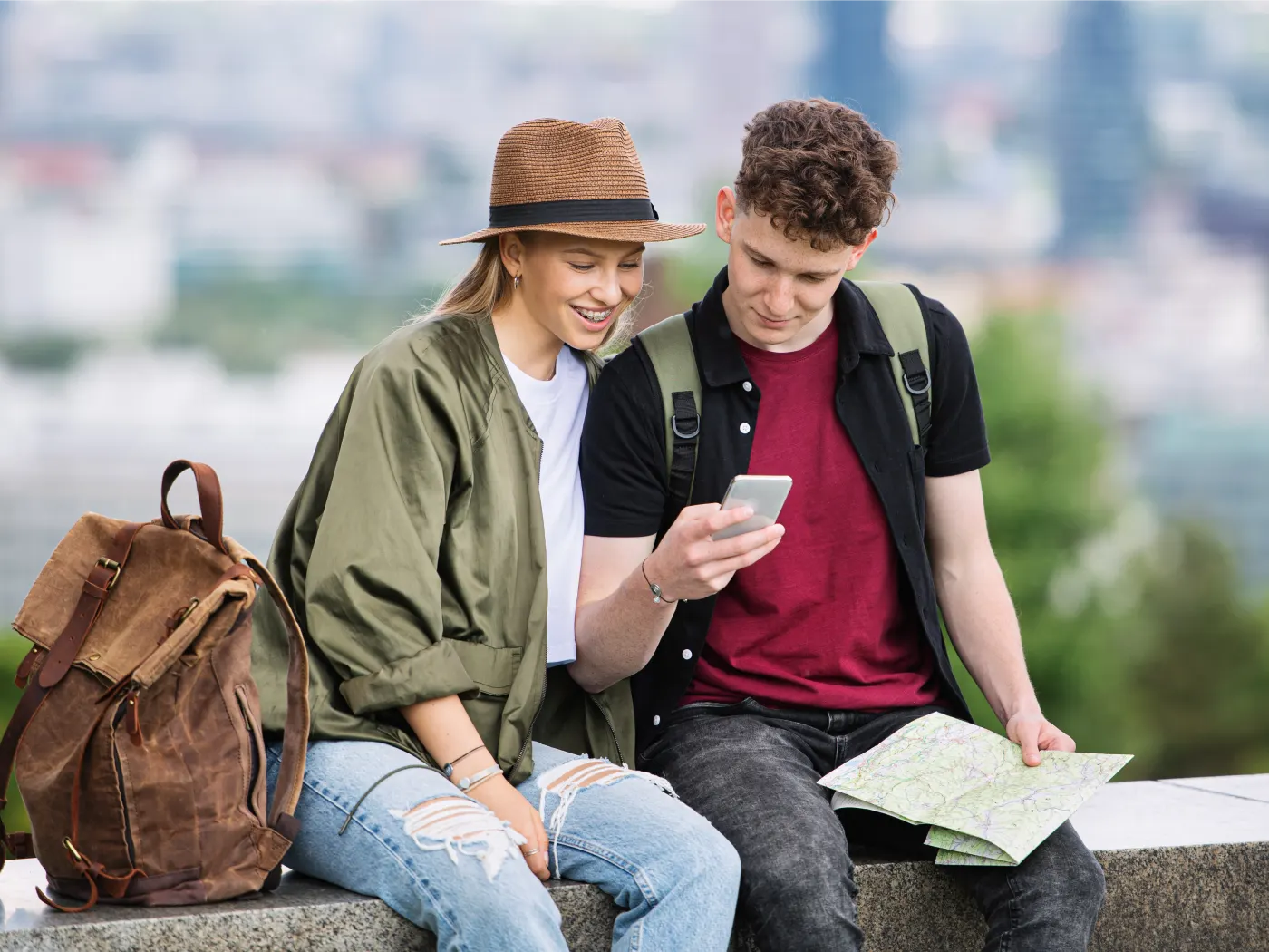 young couple travelers looking at phone