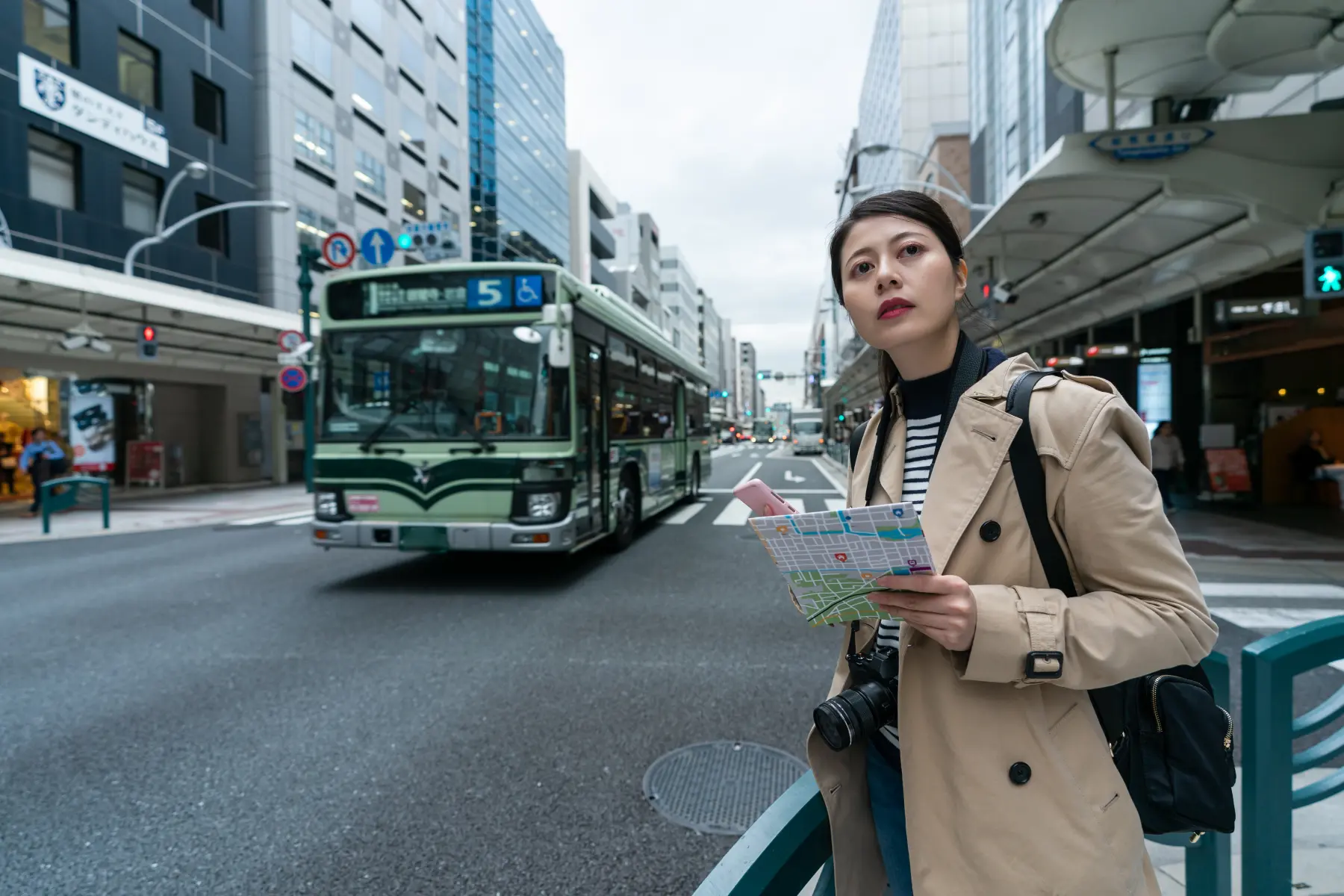lost girl with phone and map on street in kyoto